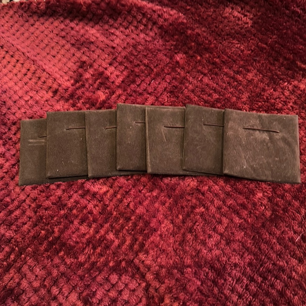 Lot of 7 brown velvet-like jewelry display mats.